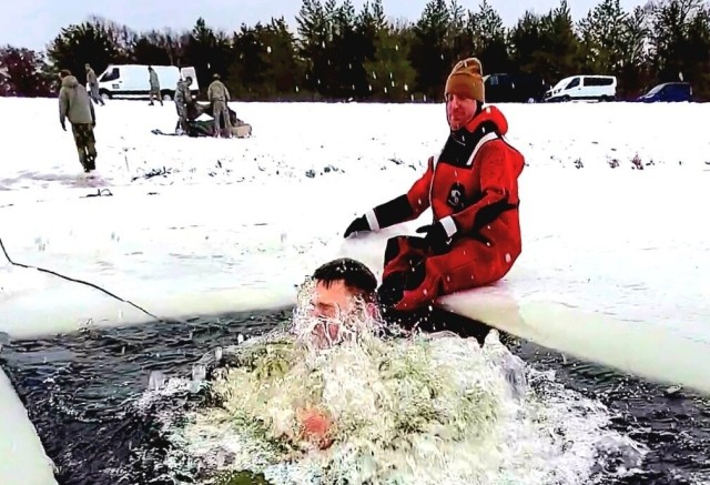 Airmen jump in icy Fort McCoy lake for January cold-water immersion training