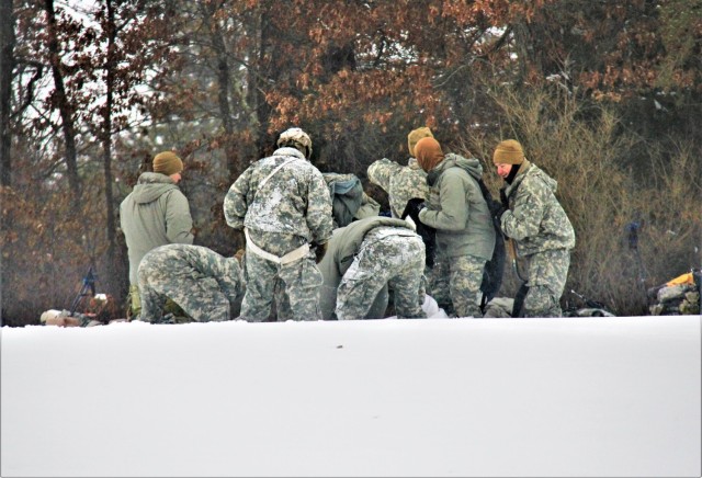 Airmen learn to build Arctic 10-person tents during cold-weather training at Fort McCoy