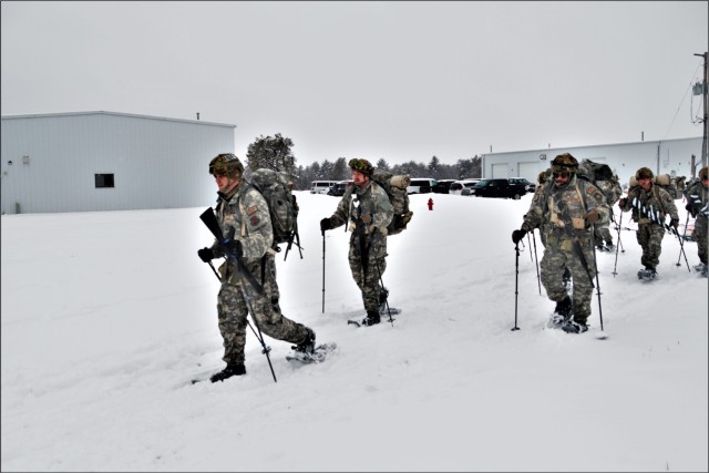Airmen with multiple Air National Guard security forces units learn squad tactics pulling an ahkio sled Jan. 19, 2023, as part of a 16-day Cold-Weather Operations Course led by the Air Force at Fort McCoy, Wis. More than 50 Airmen are participating in the training from across the Air Force. Besides learning about use of snowshoes and moving as a squad over terrain pulling an ahkio sled in a cold-weather environment, the Airmen also learned about cold-weather shelters, survival techniques, cold-weather uniform wear, and more. Fort McCoy has a long history of supporting cold-weather training. Eighty years prior to this training, in January 1943, the installation hosted winter training for the Army's 76th Division prior to the Division deploying to Europe to fight in the Battle of the Bulge in World War II. (U.S. Army Photo by Scott T. Sturkol, Fort McCoy Public Affairs Office)