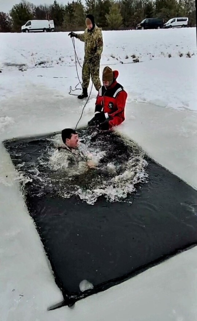 Airmen jump in icy Fort McCoy lake for January cold-water immersion training