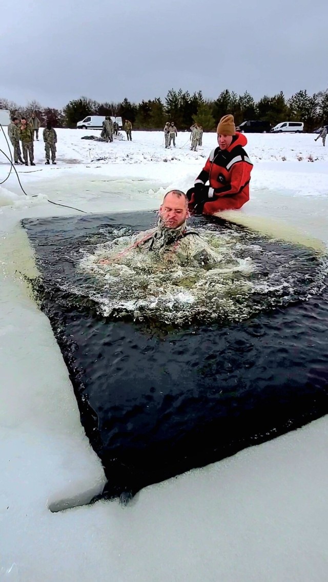 Airmen jump in icy Fort McCoy lake for January cold-water immersion training