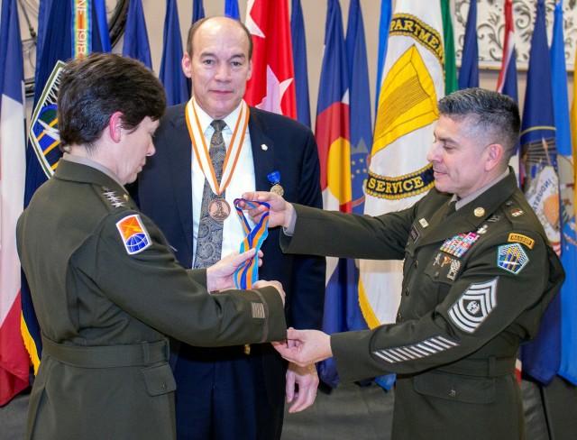 Lt. Gen. Maria B. Barrett, commanding general of U.S. Army Cyber Command (ARCYBER) and ARCYBER Command Sgt. Maj. Jack Nichols present Ronald Pontius with the Saint Isidore Cyber Award (Gold) during Pontius&#39;s retirement ceremony at Fort Gordon,...