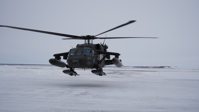 An Alaska Army National Guard UH-60L Black Hawk helicopter hovers near the aviation facility at the Bethel Airport after returning from a training flight. The helicopter is stationed in Bethel for the time being to allow aircrews to train for federal mission requirements and become more familiar with the area. (Alaska National Guard Photo by Dana Rosso)