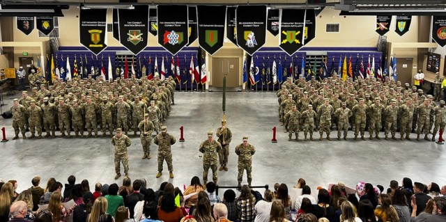 The 1st Infantry Division Headquarters and Division Artillery stand in formation in front of their families at the Fort Riley Deployment Center on Fort Riley, Kansas, Feb. 11, 2023. The Soldiers in the formation had just returned home from Europe following a year-long deployment. (U.S. Army photo by Sgt. Alvin Conley)