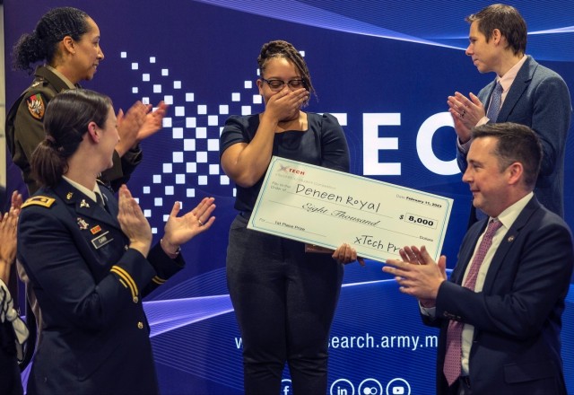 The xTechHBCU Student Competition’s first place winner (center), Deneen Royal, being presented with her first-place cash prize by Dr. Matt Willis (upper right), director, and LTC Sherida Whindleton (upper left), deputy director, of Army prize competitions and the Army Applied SBIR Program at the 2023 Black Engineer of the Year STEM Conference in National Harbor, Md. 
