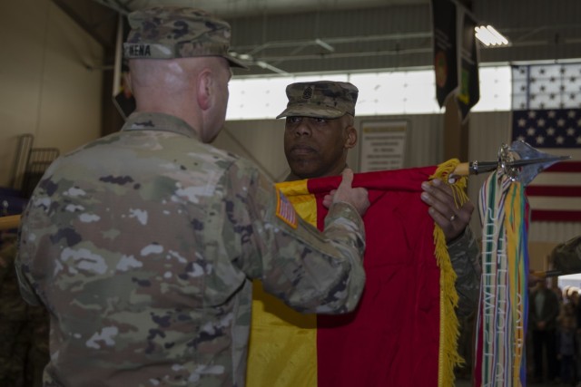 U.S. Army Col. Richard J. Ikena, the brigade commander of the 1st Infantry Division Artillery (DIVARTY), 1st Inf. Div., and Command Sgt. Maj. Michael L. McLaughlin, the brigades senior-most enlisted advisor, uncase the DIVARTY colors at an uncasing ceremony following the return of the 1st Inf. Div.-Forward and 1st Inf. Div. Headquarters from their deployment in Europe, Feb. 11, 2023, at the Fort Riley Deployment Center on Fort Riley, Kansas. The brigade spent the last year alongside the 1st Inf. Div.-Forward leading different brigades from across the Army in a series of multi-national exercises intended to strengthen interoperability and deter foreign aggression. (U.S. Army photo by Sgt. Jared Simmons)