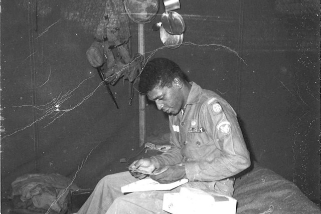 Army Sgt. 1st Class Melvin Morris looks through his belongings while deployed to Vietnam. Morris earned the Medal of Honor in 2014 for actions he took there on Sept. 17, 1969.