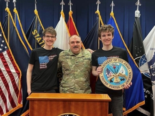 Idaho National Guard Col. Jim Hicks poses for a photo with his 19-year-old sons, Grayson, right, and Riley, Feb. 16, 2023, shortly after Hicks enlisted his sons into the Idaho Army National Guard at the Idaho Military Entrance Processing Station in Boise. The twins will serve in the same unit and in the military occupational specialty.