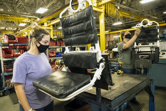 Two student trainee laborers in the Pathways Technical College program reassemble troop seats for a Stryker vehicle at Anniston Army Depot, Alabama, on April 12, 2021.