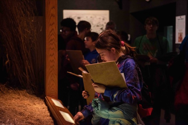 Scout Lorelei Weeks from Troop 3011 works to complete a scavenger hunt during a visit Feb. 19 to the John B. Mahaffey Museum Complex. The museum visit was part of a full day of activities coordinated for the Scouts by the Maneuver Support Center...