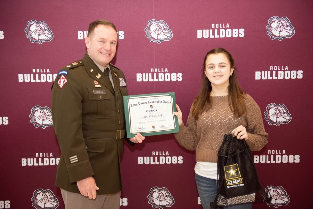 Lt. Col. John Moran, 554th Engineer Battalion commander, presents Rolla Jr. High School student, Cami Kotschedoff, with the Fort Leonard Wood Leadership Award. Cami was nominated for displaying Honor, one of the seven Army Values.