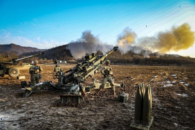 An artilleryman assigned to 2nd Battalion, 17th Field Artillery Regiment, 2nd Stryker Brigade Combat Team, 2nd Infantry Division pulls a cord to fire a M777 Howitzer during an artillery training exercise on January 12, 2023 in South Korea during Korea Rotational Force 12.