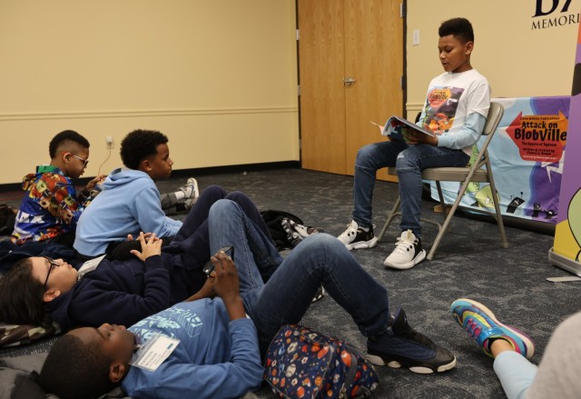 Scott Intermediate School student author Chance Brown reads from his published book, “Attack on Blobville: The Return of Bydoom” during an in-person reading event Feb. 23, 2023 at Barr Memorial Library.