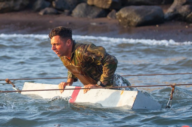 U.S. Army 1st Lt. Brendan Kalaf, the Headquarters Company, 1st Battalion, 69th Infantry Regiment, executive officer, overcomes a water obstacle during the French Desert Commando Course Jan. 30, 2023, at the Centre Dentrainment Au Combat Djibouti. Participants who completed the training received the prestigious desert commando badge.