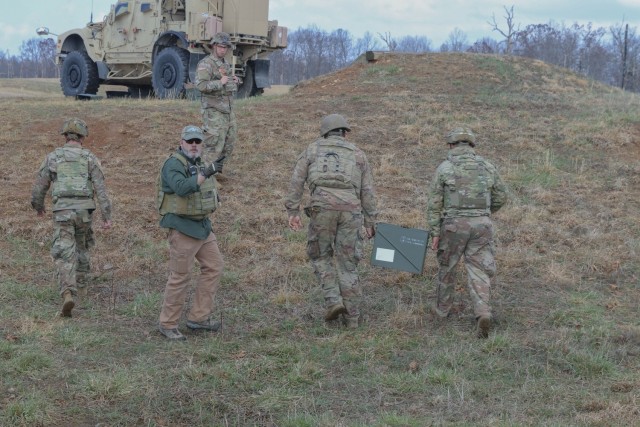 Mobile Training Team member instructs U.S. Soldiers from 1st Brigade Combat Team &#34;Bastogne&#34;, 101st Airborne Division (Air Assault) as they prepare to load munitions on to a Mine-Resistant Ambush Protected vehicle during a counter-UAS live...