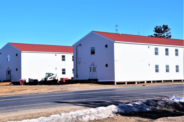 Contractors moving four World War II-era barracks buildings at Fort McCoy