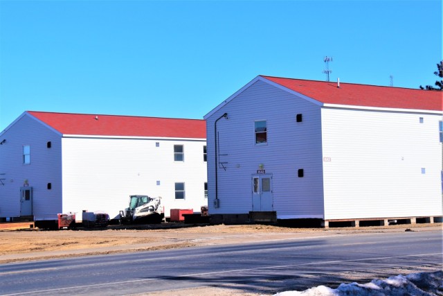 Contractors moving four World War II-era barracks buildings at Fort McCoy