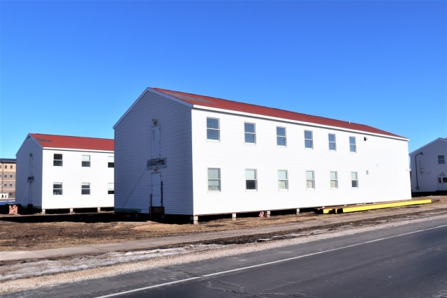 Contractors moving four World War II-era barracks buildings at Fort McCoy