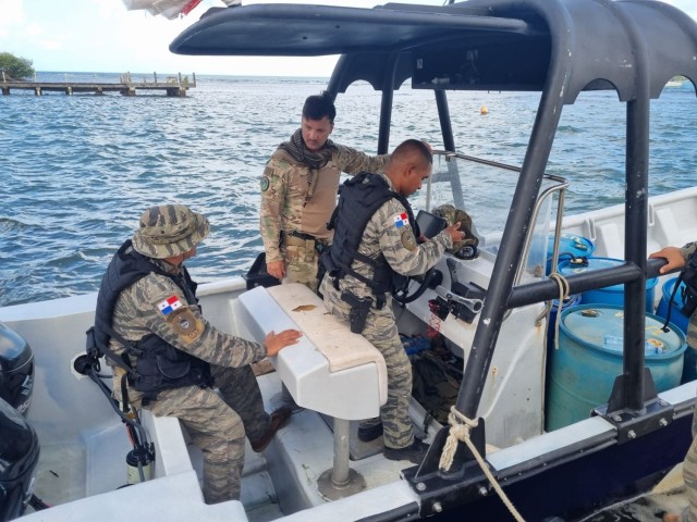 A trainee questions Sgt. 1st Class Jose Santiago on watercraft operations.