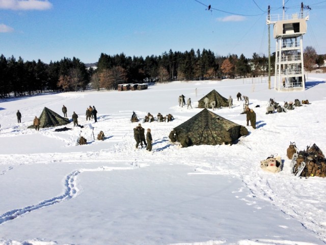 Students in the Cold-Weather Operations Course (CWOC) Class 18-04 build Arctic 10-person tents as part of the course training Feb. 7, 2018, at Fort McCoy, Wis. The students included Marines and Soldiers. In addition to tent building, CWOC students are trained on a variety of cold-weather subjects, including snowshoe training and skiing as well as how to use ahkio sleds and other gear. Training also focuses on terrain and weather analysis, risk management, cold-weather clothing, developing winter fighting positions in the field, camouflage and concealment, and numerous other areas that are important to know in order to survive and operate in a cold-weather environment. The training is coordinated through the Directorate of Plans, Training, Mobilization and Security at Fort McCoy. (U.S. Army Photo by Scott T. Sturkol, Public Affairs Office, Fort McCoy, Wis.)