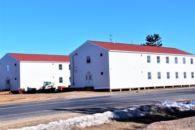 Contractors moving four World War II-era barracks buildings at Fort McCoy