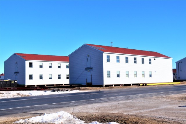 Contractors moving four World War II-era barracks buildings at Fort McCoy