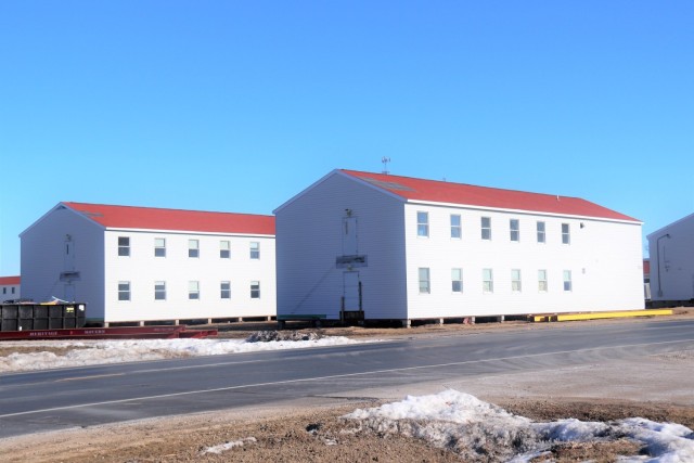 Contractors moving four World War II-era barracks buildings at Fort McCoy