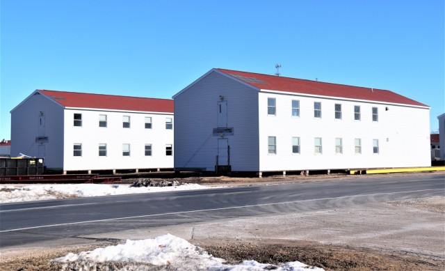 Contractors moving four World War II-era barracks buildings at Fort McCoy
