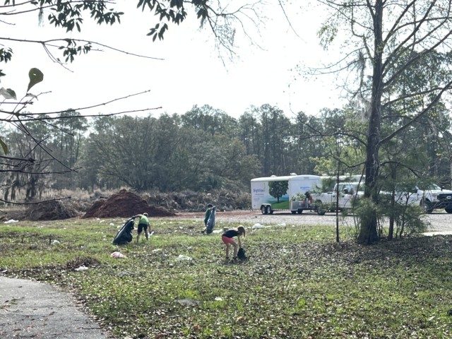 Fort Stewart youth volunteers clean up trash along one of the installation&#39;s walking trails, Feb. 25 on Fort Stewart, Georgia. The youth took it upon themselves to clean the area that had been heavily littered with trash in an effort to protect the area wildlife and keep the community beautiful. (Photo by Ali Portis)