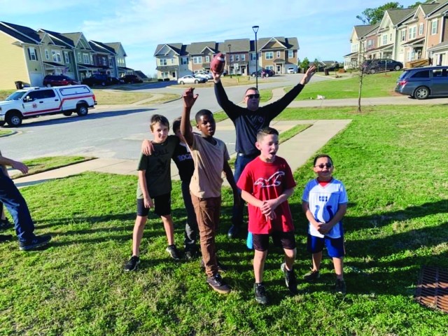 Members of the Fort Jackson Fire Department play football with residents of Fort Jackson housing community. William Sexton, a fire inspector with the FJFD saw children playing stopped by with a group of firefighters. (Courtesy Photo)