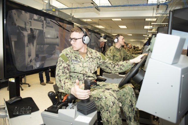 Navy Seaman Recruit Peter Morrissey, with the Fort Leonard Wood Center for Seabees and Facilities Engineering Detachment, practices moving backwards in a scraper simulator during class on Monday at the Horizontal Skills Division. 
