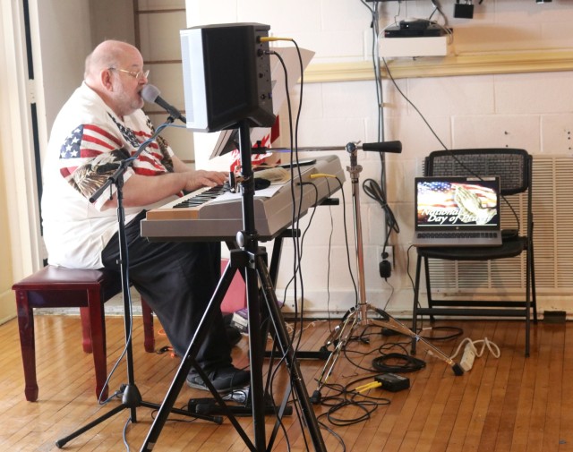 Chapel volunteer Russ Hughes performs an inspirational song