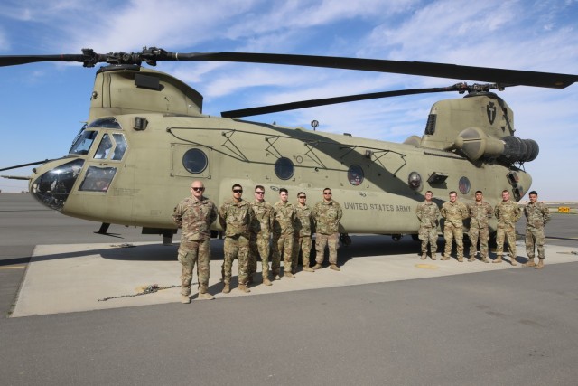 U.S. Army aviation maintenance Soldiers from Delta Company, 2nd Battalion, 149th Aviation Regiment, General Support Aviation Battalion, 36th Combat Aviation Brigade, &#34;Task Force Mustang,&#34; gather in front of a readied CH-47F Chinook helicopter at the Udairi Landing Zone in Camp Buehring, Kuwait, Feb. 18, 2023. Left to right: Spc. Jacob Hess, Pfc. Kaleb Fegurgur, Sgt. Adam Scheef, Spc. Sydney McElhany, Spc. Jacob Carreon, Spc. Jorge Gonzalez, Spc. Matthew Glover, Spc. Austin Chancellor, Spc. Louie Chacon, Staff Sgt. Nicholas Schupe, and Sgt. Kevin Vasquez. (U.S. Army photo by Capt. Steven L. Wesolowski, 36th CAB Public Affairs)