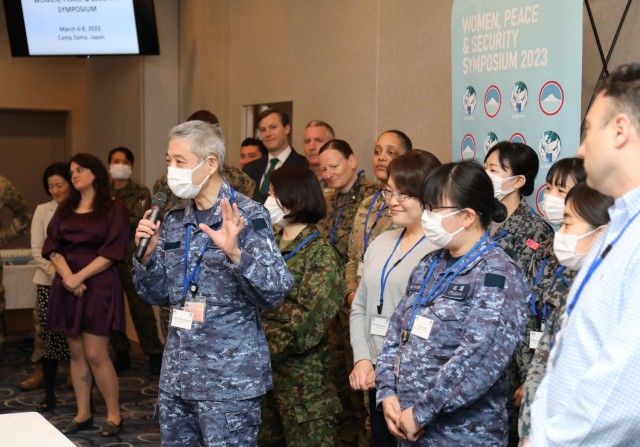 Participants in the U.S. Army Japan&#39;s inaugural Women, Peace and Security symposium join in an icebreaker game inside the Camp Zama Community Club, Japan, March 6, 2023. The three-day event had speakers, panel discussions and breakout sessions to promote a gendered perspective and women’s equal involvement in decision-making.