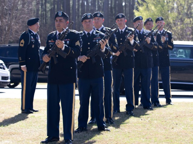 Members of the Fort Jackson rifle salute team renders honors as retired Command Sgt. Maj. Russel Anderson is loaded into a hearse for movement to his interment at the Fort Jackson National Cemetery.