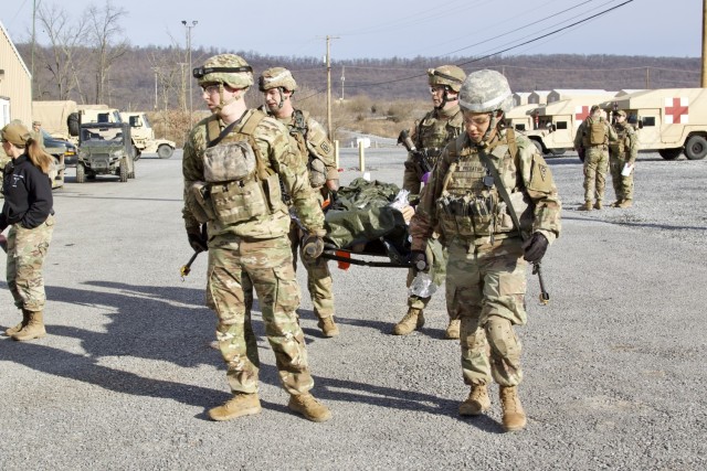 U.S. Soldiers carry a simulated casualty to a field hospital during an exercise at Fort Indiantown Gap, Pennsylvania, March 3, 2023. This exercise included responding to the scene of a mass casualty event, providing first aid and evacuating the simulated casualties to a field hospital while being assessed by instructors with the Pennsylvania National Guard’s 4th Battalion, 166th Regiment Regional Training Institute (Medical Battalion Training Site). (U.S. Army National Guard photo by Maj. Travis Mueller)
