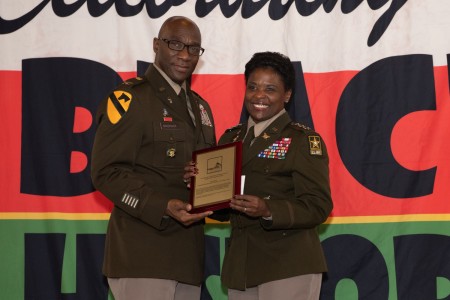 Gospel Service Chaplain (Col.) Willie Mashack, Chaplain Corps Campaign Plan Officer, Office of the Chief of Chaplains, presents LTG Donna W. Martin, the Inspector General, the Keeper of the Community Award, for her influence and work in Army service at a ceremony on Feb. 25, 2023, at the Memorial Chapel at Joint Base Myer-Henderson Hall. 
