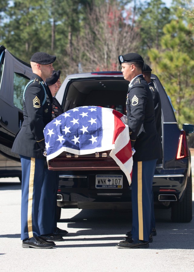 Members of the Fort Jackson honor guard from Headquarters, Headquarters Battalion, remove the casket prior to the interment of retired Command Sgt. Maj. Russel Anderson, Feb. 28 at the Fort Jackson National Cemetery