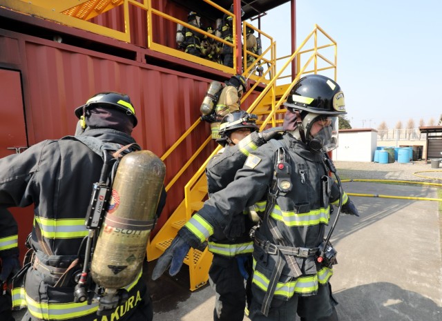 U.S. Army Garrison Japan firefighters prepare to enter a new live-fire training facility at Sagami General Depot, Japan, March 9, 2023. After being trained by contractors on the facility earlier this year, the USAG Japan fire department has recently begun to train its own personnel on the proper ways to handle indoor fires.