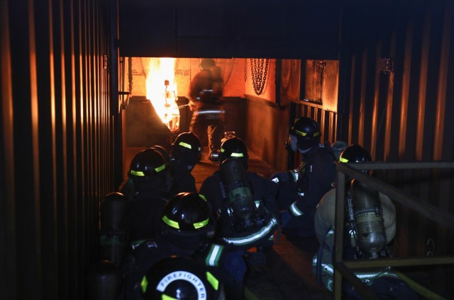 U.S. Army Garrison Japan firefighters conduct a live-fire scenario inside a new training facility at Sagami General Depot, Japan, March 9, 2023. After being trained by contractors on the facility earlier this year, the USAG Japan fire department has recently begun to train its own personnel on the proper ways to handle indoor fires.