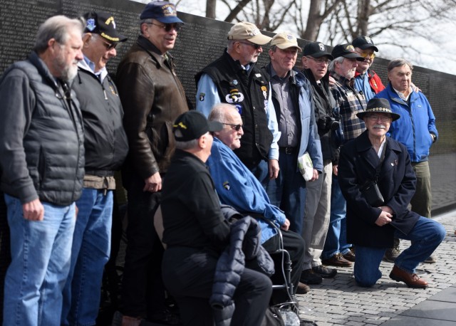 Veterans from Alpha Company, 3rd Battalion, 506th Infantry Regiment, stand together for a group photo in front of the Vietnam Veterans Memorial, Feb. 19. They come to the wall each year to honor the men who lost their lives during the war.  