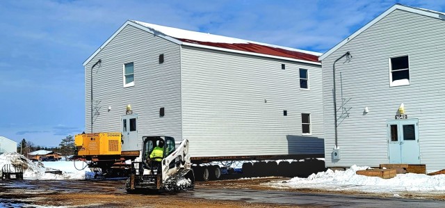 Contractors prepare World War II-era barracks buildings to be moved at Fort McCoy