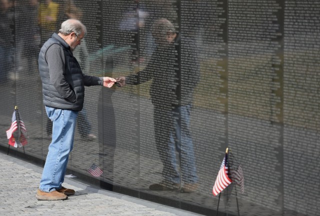 John Colone, Currahee, searches for names of the Soldiers from his company that lost their lives in the Vietnam War. 