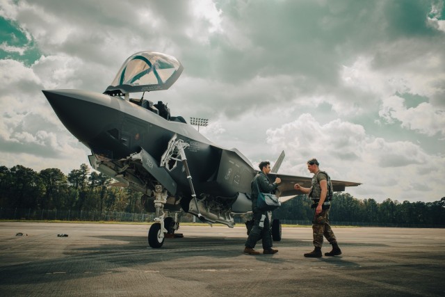 During exercise AGILE FLAG 23-1, Air Force Capt. Jeremey Tuma (left), F-35 pilot with 4th Fighter Generation Squadron, 388th Fighter Wing, is greeted by Senior Airman Brett Burkle (right), crew chief with 4th FGS, after landing on the simulated...