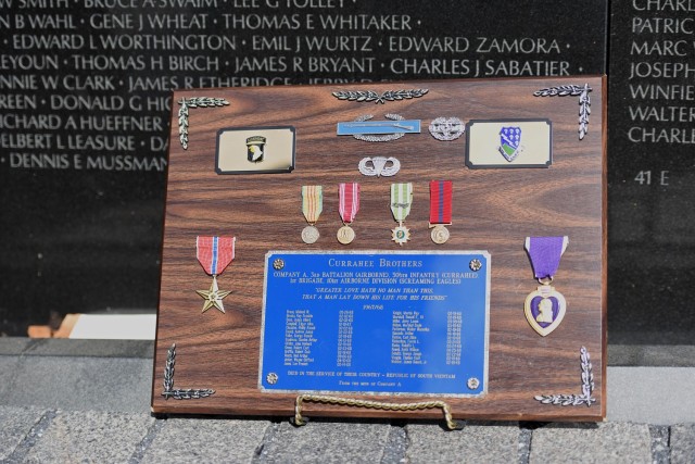 A plaque with the 26 names of the men from Alpha Company, 3rd Battalion, 506th Infantry Regiment, who lost their lives is placed in front of the Vietnam Veterans Memorial. 
