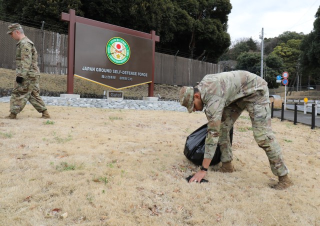 Pvt. Joseph Hensley, right, assigned to the 901st Military Police Detachment, and Sgt. 1st Class Nathan Luker, detachment sergeant for Headquarters and Headquarters Detachment, U.S. Army Garrison Japan, pick up trash near the front gate at Camp Zama, Japan, March 14, 2023. Camp Zama personnel have been beautifying the entire installation this week in advance of this year’s first open-post event. 