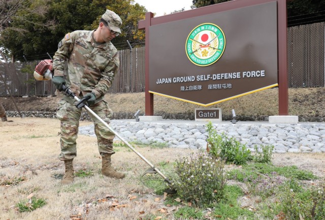 Staff Sgt. Christopher Williams, assigned to the U.S. Army Japan Band, cuts overgrown grass and weeds near the front gate at Camp Zama, Japan, March 14, 2023. Camp Zama personnel have been beautifying the entire installation this week in advance of this year’s first open-post event. 