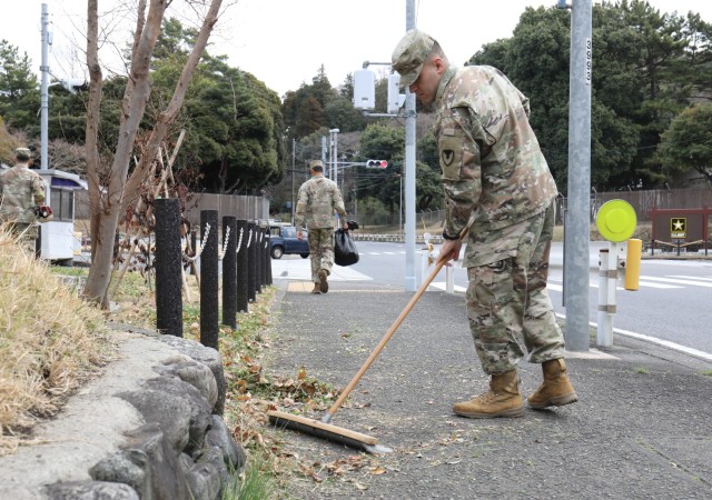 Pvt. Keith Tourtillott, assigned to the 901st Military Police Detachment, sweeps away debris from a sidewalk near the front gate at Camp Zama, Japan, March 14, 2023. Camp Zama personnel have been beautifying the entire installation this week in advance of this year’s first open-post event. 