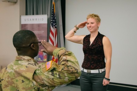 Capt. Sara Johnston, U.S. Army Reserve, exchanges a salute with her recruiter, Sergeant First Class Travis Morrisey. Johnston, a scientist at U.S. Army Medical Research Institute of Infectious Diseases, commissioned as a 71A (microbiologist) Jan. 27, 2023, in a Fort Detrick, Md. ceremony.