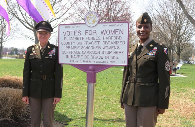 From left, Command Sgt. Maj. Kristie Brady of the U.S. Army Communications-Electronics Command and APG Garrison Command Sgt. Maj. Ruth Drewitt pose by the new “Votes for Women” historical marker in Ha